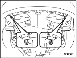 The front tie-down hooks are located between each of the front tires and the front bumper.