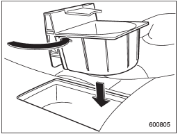 The divider in the cup holder can be pulled out and inserted in a different position (further toward the front or rear) to enable cups of different sizes to be held.