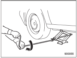 10. Insert the jack handle into the jackscrew, and turn the handle until the tire clears the ground. Do not raise the vehicle higher than necessary.